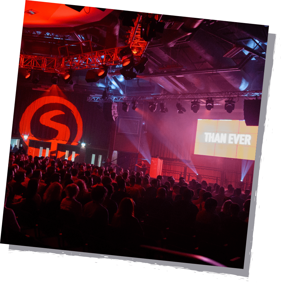 SDC24 - website promo image A red speaker hall from Sumo Developer Conference 2023 pictured