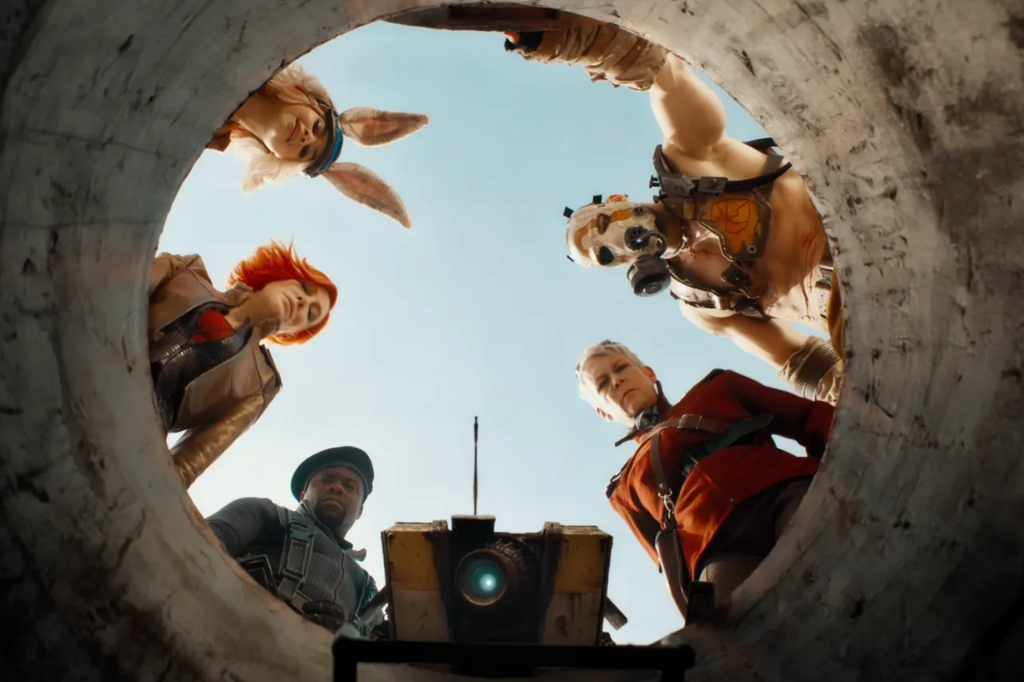 Six characters from the movie 'Borderlands' look down at the camera seeming to be peering into a hole.