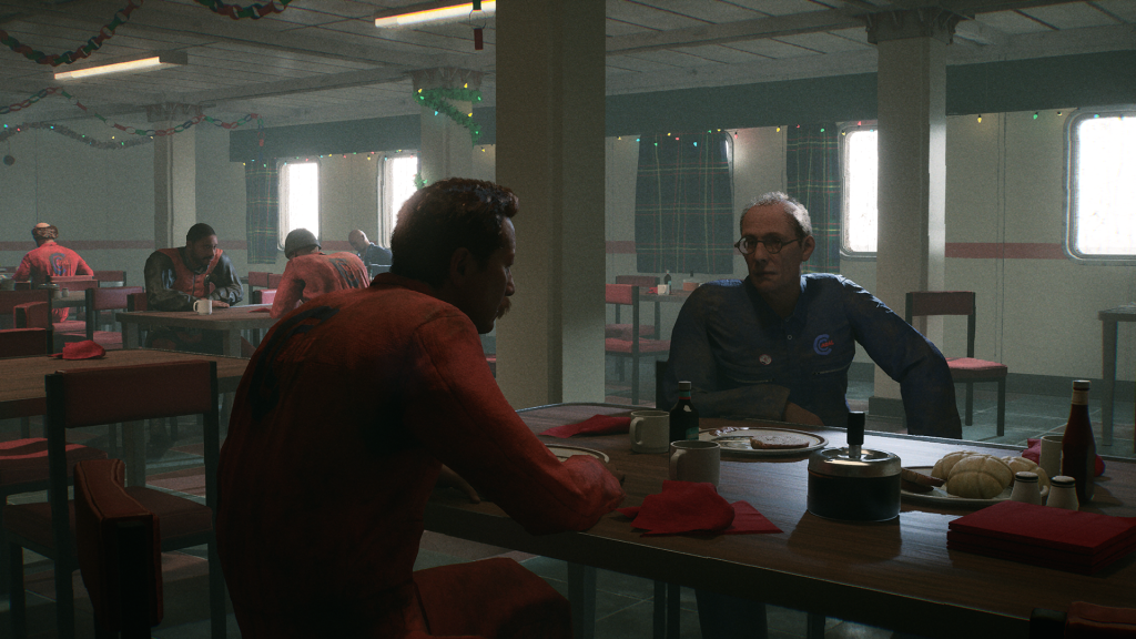 A screenshot from Still Wakes the Deep. Set in a canteen in the 70s, it's Christmas - small lights twinkle in the background. In the foreground, two characters are sat at a bench seat mid-conversation having just eaten their lunch, in the background you can see others having similar conversations. All are hunched over tables and wearing uniforms.