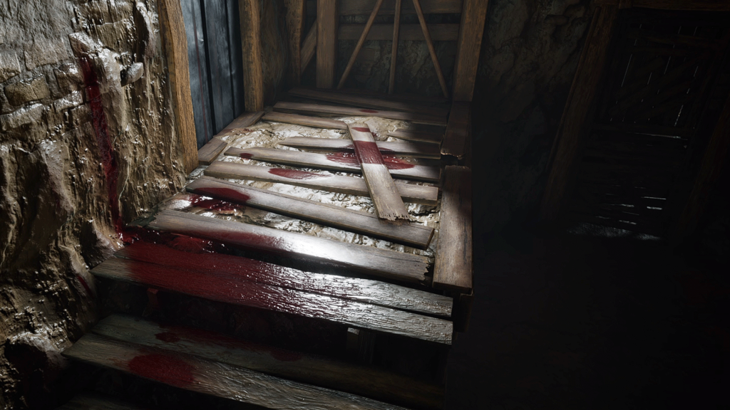 An early in-game test of blood for The Texas Chain Saw Massacre. The test blood is scattered on a wooden plank-like surface with a natural daylight source shining directly down.