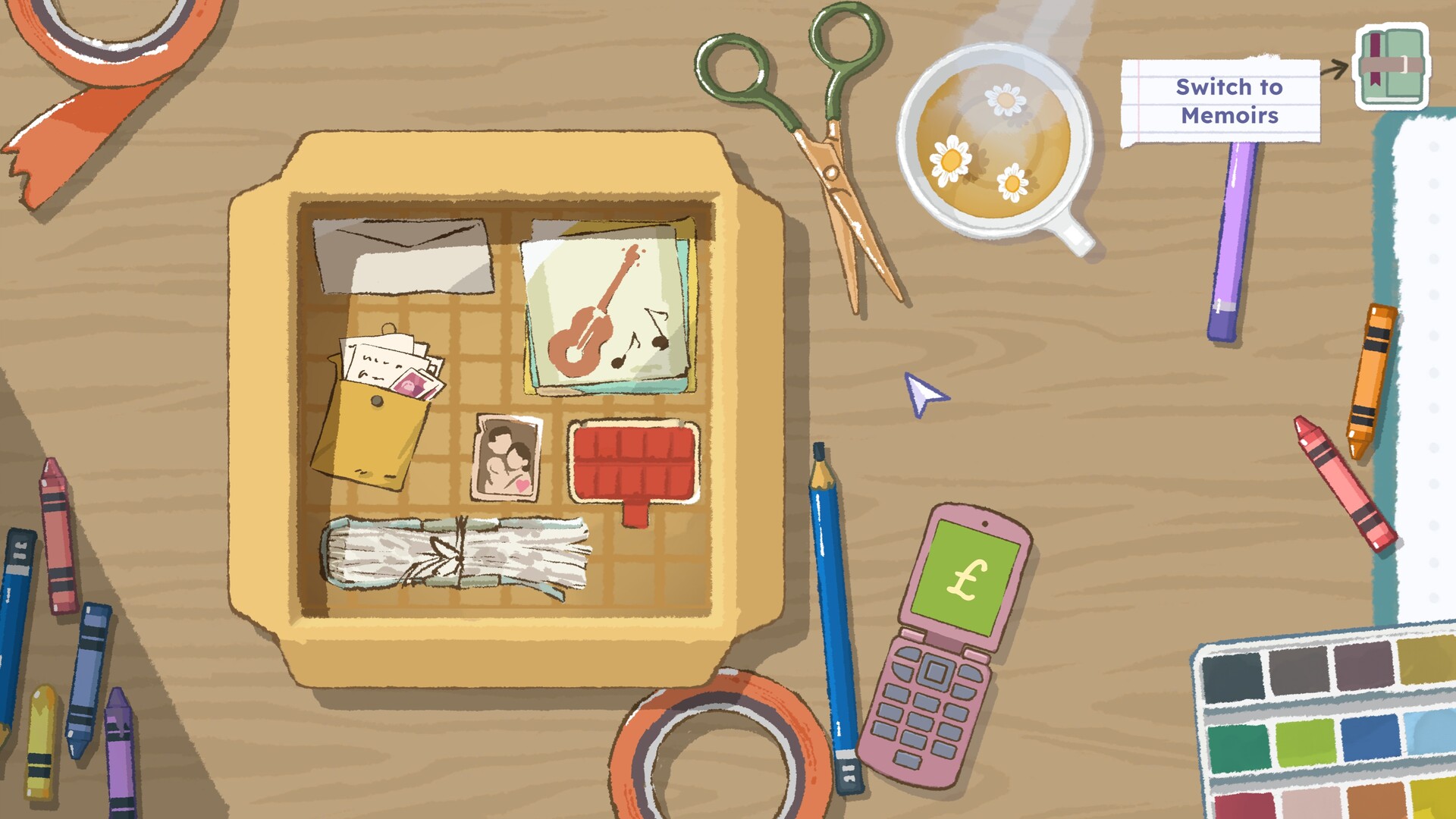 A screenshot from the game A Storied Life: Tabitha showing a stylised, hand drawn artstyle with soft yet bright colours. The art depicts a wooden table with a cardboard box on top with a grid inside, designed for the player to fit in various sized objects inside like a puzzle. Some of these items include printed our pictures, letters, music sheets, envelopes and notebooks. On the table strewn around are some crayons, a mug of hot chamomile tea, scissors, and tape.