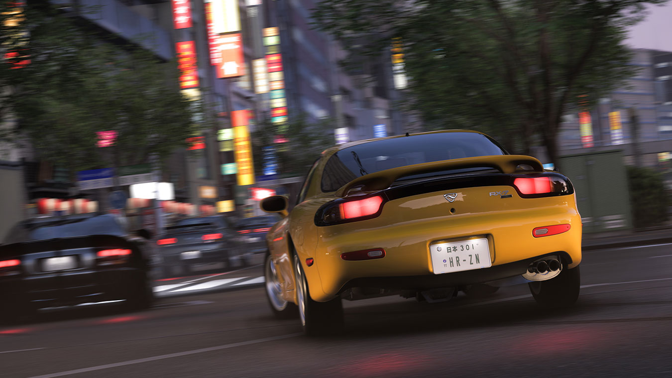 A yellow sports car with illuminated rear lights speeds through a city street at night, surrounded by blurred lights and buildings, whilst another car follows closely behind.